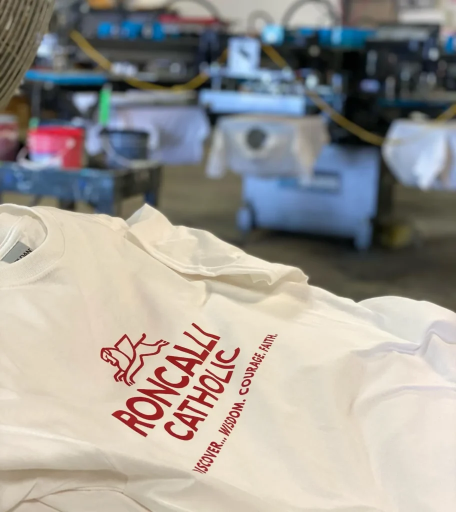 White Roncalli Catholic t-shirt with red screen printing